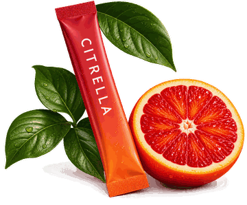 A Citrella sachet resting against a halved blood orange and green leaves